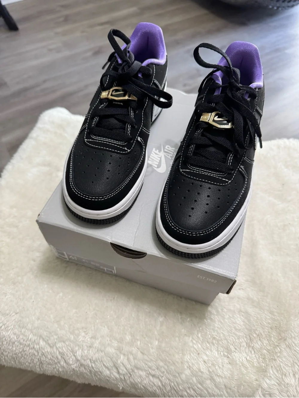 Nike Kids Black Sneakers with Purple Lining and Gold Lace Accent
